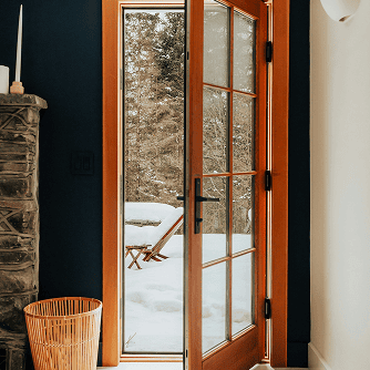 A door leading to a snowy outside framed with Douglas Fir lumber