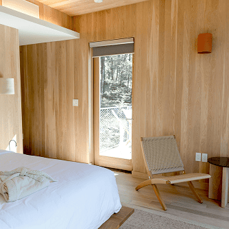 Interior picture of a bedroom with a wall paneled with Hemlock lumber