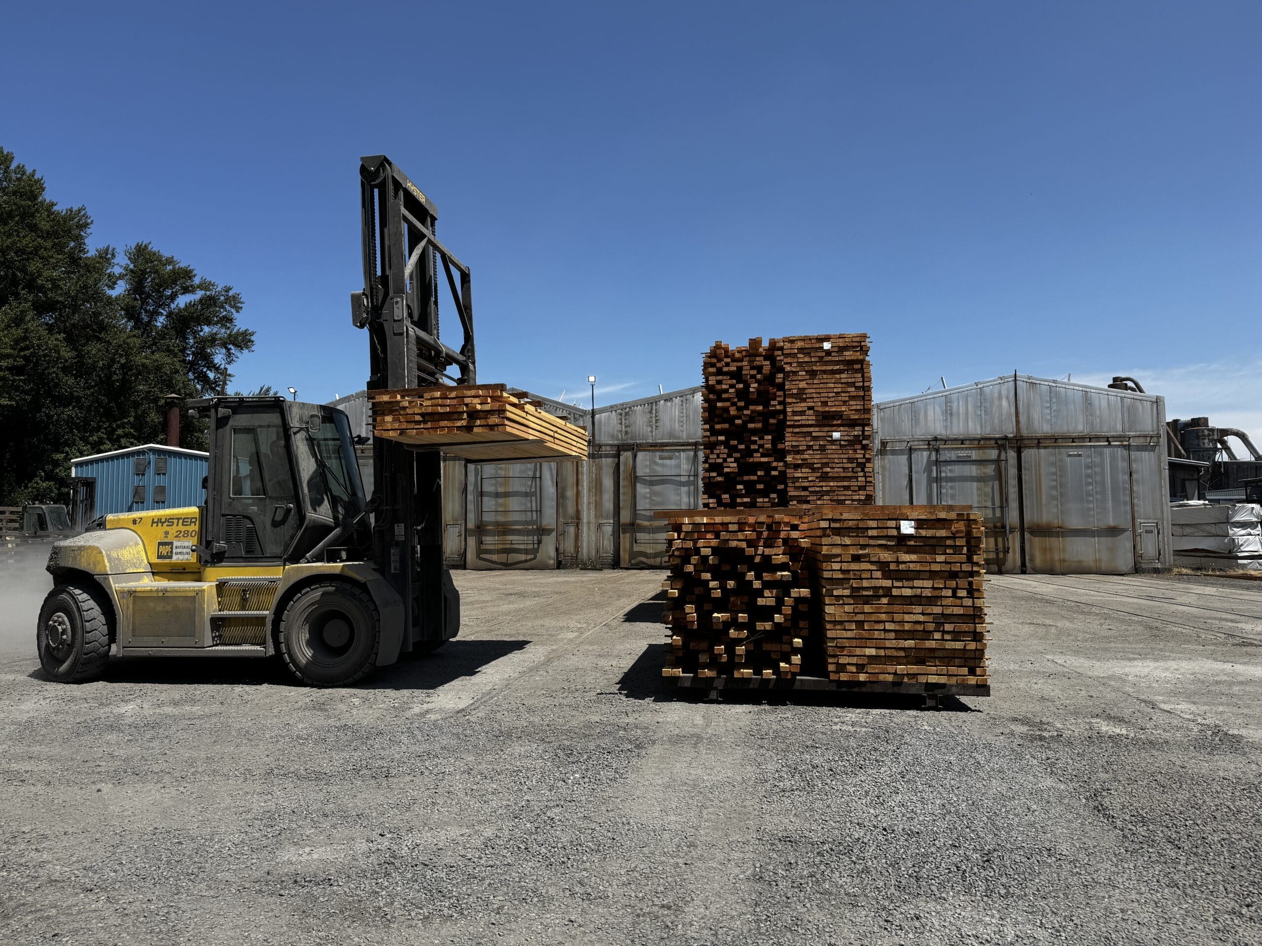 Forklift loading a stack of lumber that has been dried in a kiln